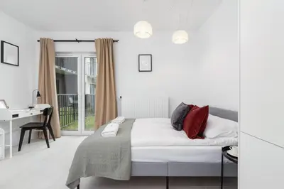 a bedroom with a bed and a desk and a window at Modern Studio & Terrace Kiełkowskiego by Noclegi Renters in Kraków