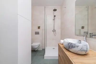 a bathroom with a sink and a shower at Modern Studio & Terrace Kiełkowskiego by Noclegi Renters in Kraków