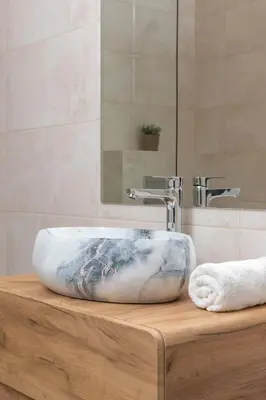 a bathroom tub with a marble sink and a mirror at Modern Studio & Terrace Kiełkowskiego by Noclegi Renters in Kraków