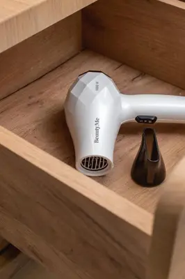 a hair dryer sitting on top of a drawer at Modern Studio & Terrace Kiełkowskiego by Noclegi Renters in Kraków