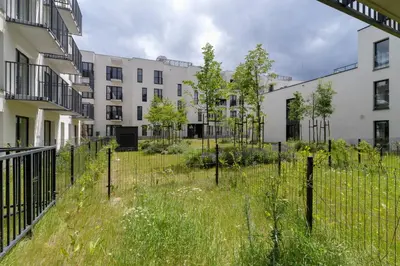 a fence in front of an apartment complex at Modern Studio & Terrace Kiełkowskiego by Noclegi Renters in Kraków