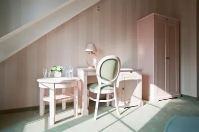 a room with a table and a chair and a desk at Dworek nad Rozlewiskiem in Olkusz