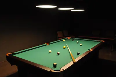 a green pool table with balls on it at Dworek nad Rozlewiskiem in Olkusz