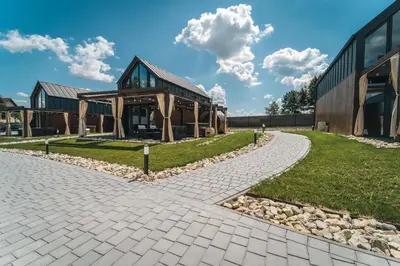 a stone walkway leading to a building at VILLAGE RESORT Sauna & Jacuzzi & Netflix in Tworkowa