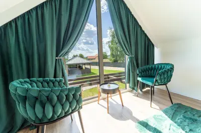 a living room with green chairs and a large window at VILLAGE RESORT Sauna & Jacuzzi & Netflix in Tworkowa