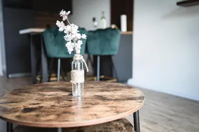 a vase of flowers sitting on top of a table at VILLAGE RESORT Sauna & Jacuzzi & Netflix in Tworkowa