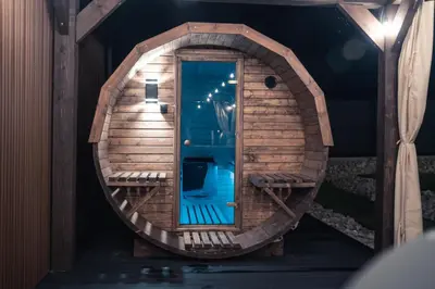 a small wooden house with a blue inside at VILLAGE RESORT Sauna & Jacuzzi & Netflix in Tworkowa