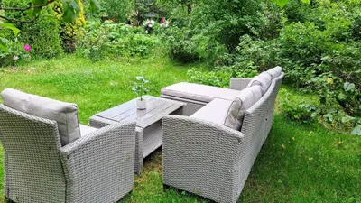 three wicker chairs and a table in a yard at Limanowa Sunriser Apartment in Limanowa