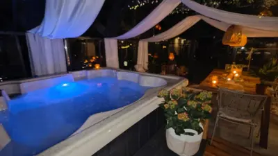 a jacuzzi tub in a room with a table at Domek Zielone Marzenie in Chrzanów