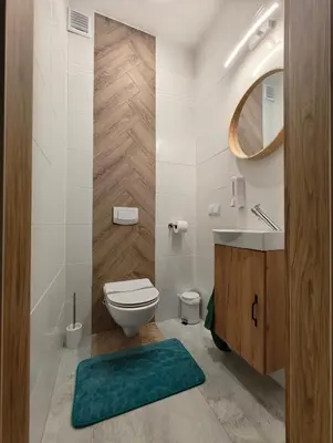 a bathroom with a toilet and a sink and a mirror at Domek Zielone Marzenie in Chrzanów