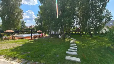 a grassy area with a stone path in a park at Domek Zielone Marzenie in Chrzanów