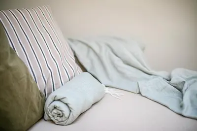 a blanket and pillows on top of a couch at Królewska Deluxe Comfy Apartment by BookingHost in Kraków