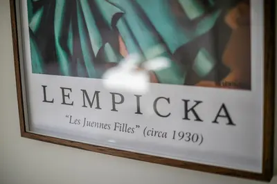 a framed picture of leevinica on a wall at Królewska Deluxe Comfy Apartment by BookingHost in Kraków