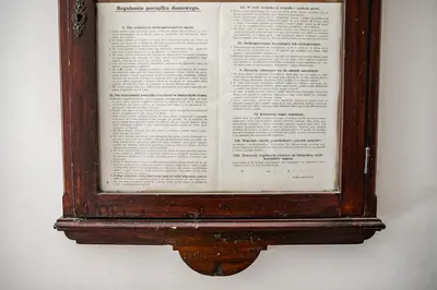 an open book is hanging on a wall at Królewska Deluxe Comfy Apartment by BookingHost in Kraków