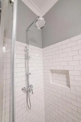 a shower in a bathroom with white tiles at Królewska Deluxe Comfy Apartment by BookingHost in Kraków
