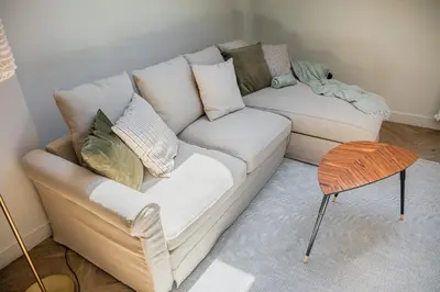 a living room with a white couch and a table at Królewska Deluxe Comfy Apartment by BookingHost in Kraków