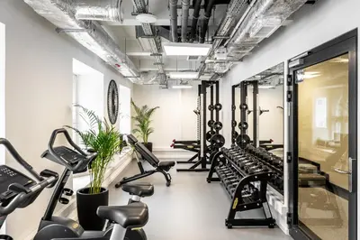 a gym with treadmills and exercise bikes at MILESTONE Krakow Center Premium Living by Tribera in Kraków