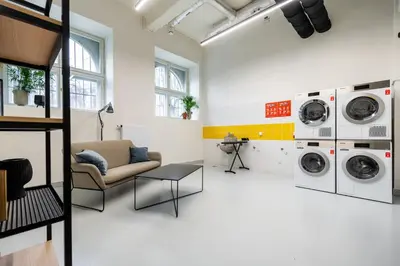 a living room with two washing machines and a couch at MILESTONE Krakow Center Premium Living by Tribera in Kraków