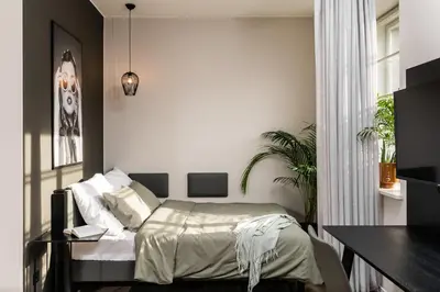 a bedroom with a bed and a dining table at MILESTONE Krakow Center Premium Living by Tribera in Kraków