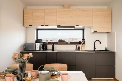 a small kitchen with a table and a window at Szczyt Beztroski- Domki Wellness Balia & Sauna in Nowy Targ