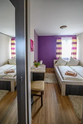 a small room with two beds and a table at Hotel Restauracja Sara in Laskowa