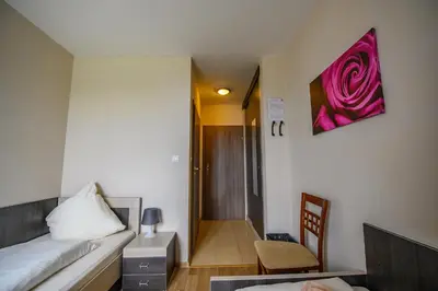 a bedroom with a bed and a chair and a table at Hotel Restauracja Sara in Laskowa