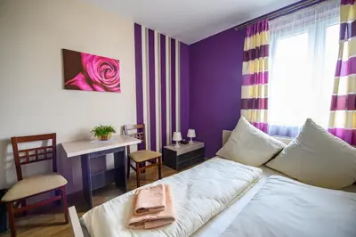 a living room with a bed and a table and a desk at Hotel Restauracja Sara in Laskowa