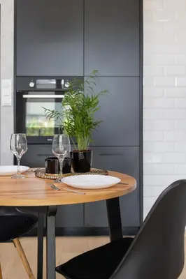 a table with two glasses and a plant on it at Kraków Studio with Parking & Terrace near Zalew Bagry by Renters Prestige in Kraków