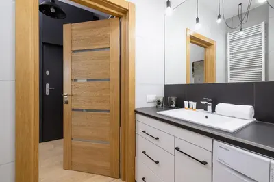a bathroom with a sink and a mirror at Kraków Studio with Parking & Terrace near Zalew Bagry by Renters Prestige in Kraków