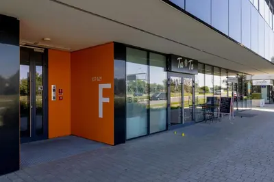a store front with an orange and black facade at Kraków Studio with Parking & Terrace near Zalew Bagry by Renters Prestige in Kraków
