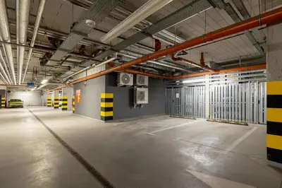 an empty parking garage with yellow and black stripes on the walls at Kraków Studio with Parking & Terrace near Zalew Bagry by Renters Prestige in Kraków