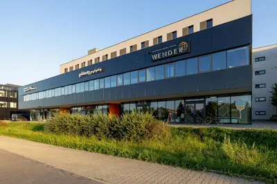 a building with a sign on the side of it at Kraków Studio with Parking & Terrace near Zalew Bagry by Renters Prestige in Kraków