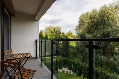 a balcony with a bench and a view at City of the Kings-Julia Apartment in Kraków