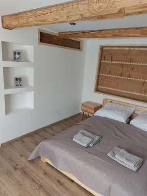 a bedroom with a bed with two towels on it at Agroturystyka ,Jarzębina' in Harkabuz