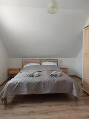 a bedroom with a bed with a blanket on it at Agroturystyka ,Jarzębina' in Harkabuz
