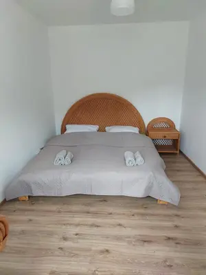a bedroom with a bed with two towels on it at Agroturystyka ,Jarzębina' in Harkabuz