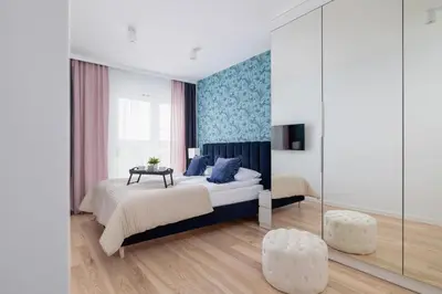 a bedroom with a king sized bed and a mirror at Vetulaniego Apartment with Air Conditioning & Parking by Renters Prestige in Kraków