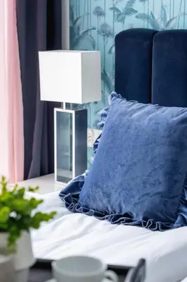 a bed with a blue pillow and a lamp on a table at Vetulaniego Apartment with Air Conditioning & Parking by Renters Prestige in Kraków