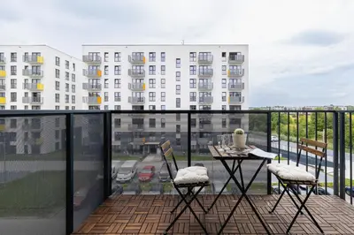 a balcony with a table and chairs and a view of a building at Vetulaniego Apartment with Air Conditioning & Parking by Renters Prestige in Kraków