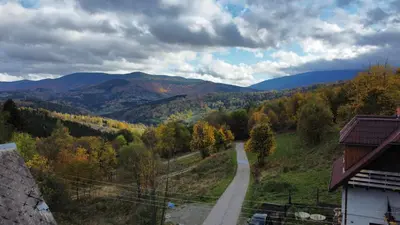 a road in the middle of a valley with mountains at Zawoja u Zbója in Zawoja