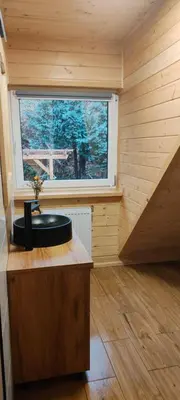 a small bathroom with a sink in a room with a window at Zawoja u Zbója in Zawoja