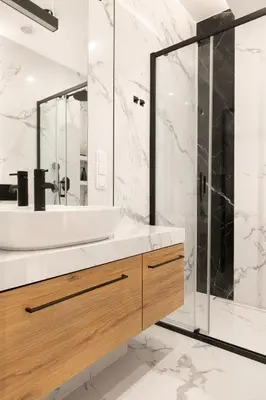 a bathroom with a sink and a shower at Modern Apartment with Air Conditioning, Old Town & Vistula River in Kraków