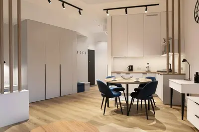 a kitchen and dining room with a table and chairs at Modern Apartment with Air Conditioning, Old Town & Vistula River in Kraków