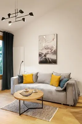 a living room with a couch and a table at Modern Apartment with Air Conditioning, Old Town & Vistula River in Kraków