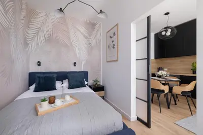 a bedroom with a bed and a dining room at Beautiful Steam Park Apartment with Parking Old Town Cracow by Noclegi Renters in Kraków