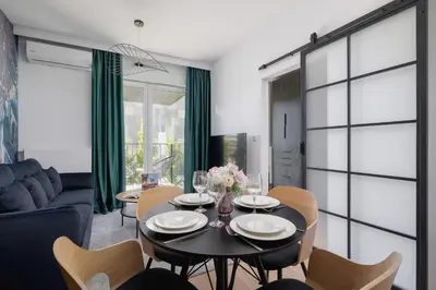 a dining room with a table and chairs at Beautiful Steam Park Apartment with Parking Old Town Cracow by Noclegi Renters in Kraków