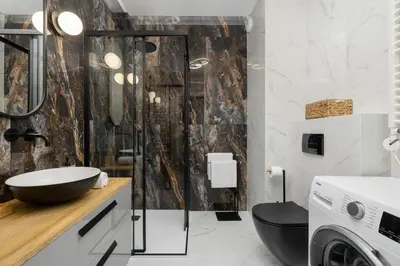 a bathroom with a black toilet and a sink at Beautiful Steam Park Apartment with Parking Old Town Cracow by Noclegi Renters in Kraków