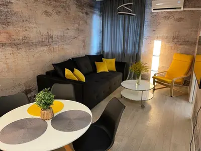 a living room with a couch and a table and chairs at COMFORT Apartment Pawia street - free parking !!! in Kraków
