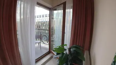 a room with a large window with a plant next to it at COMFORT Apartment Pawia street - free parking !!! in Kraków