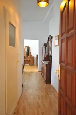 a hallway with a wooden floor and a door at Old Town Sky Apartment in Kraków